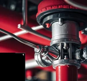 Close-up of a red fire protection valve assembly
